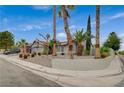 Charming single-story home featuring desert landscaping and mature palm trees at 770 Autumn Moon Dr, Las Vegas, NV 89123