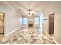 Cozy living room area with tile flooring, a fireplace, and neutral colored walls at 8220 Desert Beach Dr, Las Vegas, NV 89128