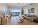Bright living room with hardwood floors, large windows, and comfortable seating at 8255 Las Vegas Blvd # 1905, Las Vegas, NV 89123
