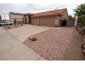 Single story home featuring desert landscaping, a terracotta roof, with a spacious two car garage at 904 Swift Bear St, Henderson, NV 89002