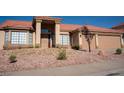 Charming single story home with desert landscaping and terracotta tile roof and a sheltered doorway at 904 Swift Bear St, Henderson, NV 89002