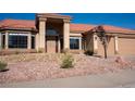 Charming single story home with desert landscaping and terracotta tile roof and a sheltered doorway at 904 Swift Bear St, Henderson, NV 89002