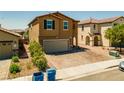Two-story home with a two-car garage and a paved driveway at 9163 W Torino Ave, Las Vegas, NV 89148