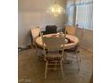 A cozy dining area with a round table, four chairs, and a chandelier at 9225 Lady Palm Ct, Las Vegas, NV 89147