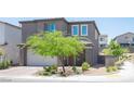 Modern two-story home with a two-car garage and landscaped front yard in a residential neighborhood at 9451 Lunar Ray St, Las Vegas, NV 89143