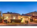 Charming home exterior featuring a manicured lawn and an attached two-car garage at 9733 Plateau Heights Pl, Las Vegas, NV 89144