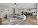 Open-concept living space featuring modern furnishings and wood-look floors at 10161 Bismarck Palms Ave, Las Vegas, NV 89166