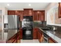 Gourmet kitchen features stainless steel appliances, granite countertops, and custom cabinetry at 11755 Garland Grove Ln, Las Vegas, NV 89183