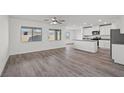 Open-concept living space with wood-look floors connecting to the kitchen at 1701 Desert Path Ave, North Las Vegas, NV 89032