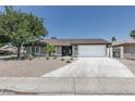 Charming single-story home with a well-maintained lawn and a spacious two-car garage, offering both style and functionality at 1852 E Viking Rd, Las Vegas, NV 89169