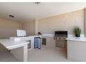 Modern outdoor kitchen with stainless steel grill, marble countertops, and plenty of counter space at 1950 Colvin Run Dr, Henderson, NV 89052