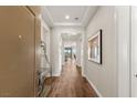 Elegant home entryway with hardwood floors, recessed lighting, and modern artwork on display at 2069 Alto Vista Dr, Henderson, NV 89052