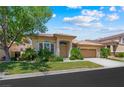 Charming single-story home featuring a well-manicured lawn and attached two-car garage at 2113 Scarlet Rose Dr, Las Vegas, NV 89134