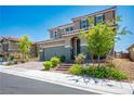 Two-story home boasting a tile roof, green shutters, lush landscaping, and a two-car garage at 2577 Tolmezzo St, Henderson, NV 89044