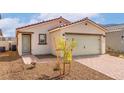 A well-maintained single-story home with a two-car garage, desert landscaping, and a brick driveway at 2618 Lily Point St, Las Vegas, NV 89156