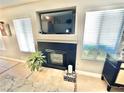 Close-up of fireplace with a TV above and bright, natural lighting at 3329 Hidden Ridge St, Las Vegas, NV 89129