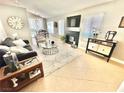 Bright living room with fireplace, modern furniture, and neutral decor at 3329 Hidden Ridge St, Las Vegas, NV 89129