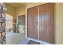 Close-up of a solid brown double front door with stone pillar accents, showcasing the home's entry at 3605 Sapphire Sea Ct, North Las Vegas, NV 89031