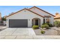 Charming home with well-maintained yard, two-car garage, and stucco walls at 4324 Peaceful Path Ct, North Las Vegas, NV 89032