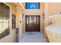 Elegant double front doors with decorative glass, framed by pillars and decorative lighting fixtures at 4620 N Tee Pee Ln, Las Vegas, NV 89129