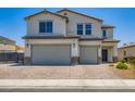 Attractive two-story home with a two-car garage and brick-paved driveway at 5660 Oasis Ridge St, North Las Vegas, NV 89031