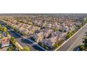 A high-angle view showcasing an extensive community of townhouses with red tile roofs in an organized street layout at 5855 Valley Dr # 2145, North Las Vegas, NV 89031