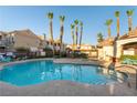 Community pool featuring tall palm trees, a jacuzzi, and ample seating for residents' relaxation and enjoyment at 5855 Valley Dr # 2145, North Las Vegas, NV 89031