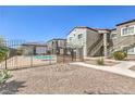 Community pool area behind a secure fence, with manicured landscaping and building in the background at 6160 Rumrill St # 215, Las Vegas, NV 89113