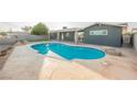 Private backyard with large in-ground pool, concrete patio, and mature landscaping at 617 6Th St, Boulder City, NV 89005