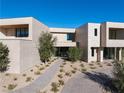 Contemporary home featuring a minimalist design with desert landscaping, offering a serene and stylish outdoor space at 68 Sun Glow Ln, Las Vegas, NV 89135