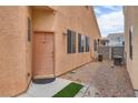 Side view of home showing gravel landscaping, small patch of green, and house details at 6916 Gothic Marigold St, Las Vegas, NV 89149