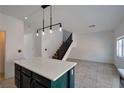 Kitchen island with pendant lighting and view of staircase at 9443 Hot Breeze St, Las Vegas, NV 89178