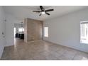 Open living room featuring tile flooring, neutral paint, and contemporary ceiling fan at 9443 Hot Breeze St, Las Vegas, NV 89178