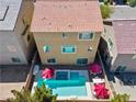 Aerial view of private backyard featuring a pool, spa, patio furniture, and lush landscaping, perfect for outdoor living at 9742 Toad Hollow St, Las Vegas, NV 89141