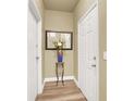 Bright entryway featuring wood-look floors, decorative mirror, and access to additional rooms at 9975 Peace Way # 2009, Las Vegas, NV 89147