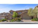 Charming two-story home featuring a well-maintained landscape, brick accents, and attached garages at 12269 Catanzaro Ave, Las Vegas, NV 89138