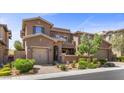 Charming two-story home featuring a well-maintained landscape, brick accents, and attached garages at 12269 Catanzaro Ave, Las Vegas, NV 89138