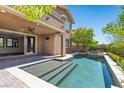 Inviting backyard pool featuring a tanning ledge, a built-in hot tub, and a covered patio at 12269 Catanzaro Ave, Las Vegas, NV 89138