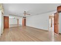 Bright living room showcasing hardwood floors, mirrored wall, and ample natural light at 1331 Melville Dr, Las Vegas, NV 89102