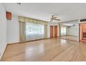Spacious living room featuring hardwood floors, large windows, and a ceiling fan at 1331 Melville Dr, Las Vegas, NV 89102