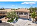 Two-story home featuring a three-car garage, balcony, neutral colors, and a manicured lawn at 1403 Graystone Canyon Ave, Las Vegas, NV 89183