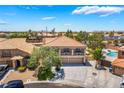 Two-story home with a balcony, three-car garage, landscaped front yard, and a tile roof at 1403 Graystone Canyon Ave, Las Vegas, NV 89183