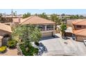 Two-story home with neutral colors, a balcony, and a three-car garage at 1403 Graystone Canyon Ave, Las Vegas, NV 89183