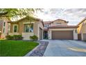 Charming two-story home features a tile roof, well-manicured lawn, and a spacious driveway at 1513 Ravanusa Dr, Henderson, NV 89052