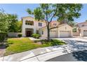 Inviting two-story home with a well-maintained lawn and a spacious three-car garage, ideal for a growing Gathering at 1813 Francisco Peak Pl, Las Vegas, NV 89128