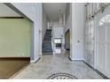 Grand entryway with marble floors, a staircase, and a view into the living room creating a lasting first impression at 1813 Francisco Peak Pl, Las Vegas, NV 89128