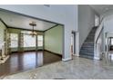 Elegant living room featuring hardwood floors, high ceilings, a fireplace, and an ornate chandelier at 1813 Francisco Peak Pl, Las Vegas, NV 89128