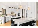Modern kitchen features white cabinetry, stainless appliances, dual islands, and a breakfast bar with seating at 4 Via Vittorio Pl, Henderson, NV 89011
