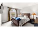 Cozy bedroom with a queen bed and a view from the window with elegant, large curtains at 4050 Pacific Harbors Dr # 127, Las Vegas, NV 89121