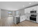 Modern kitchen featuring stainless steel appliances, quartz countertops, and bright white cabinetry at 4421 Pioche Ave, North Las Vegas, NV 89032